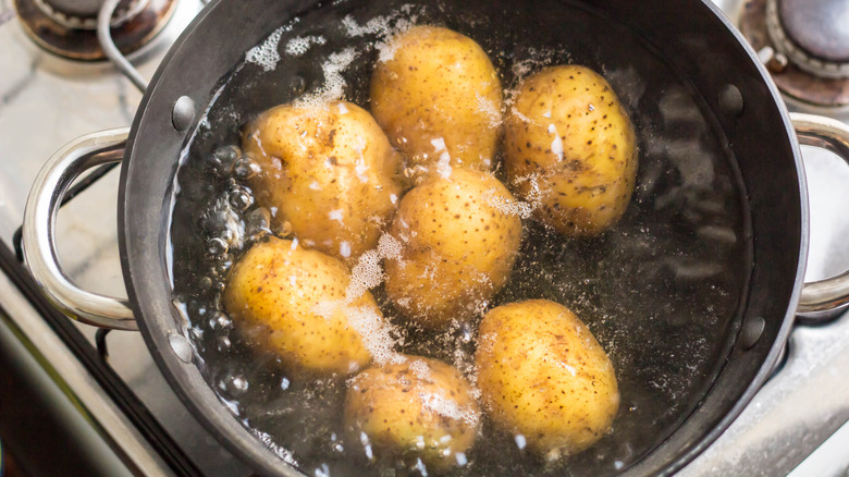 Potatoes boiling whole in a pot 