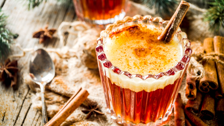 Frothy cocktail with cinnamon stick