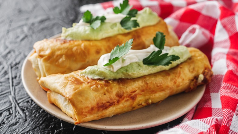 Two chimichangas on plate