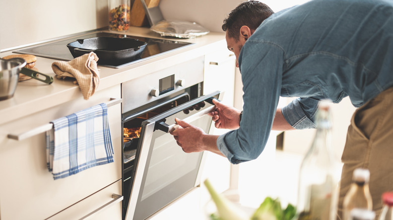 person using oven cooking