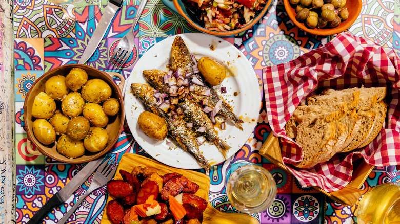 variety of dishes and plate of sardines