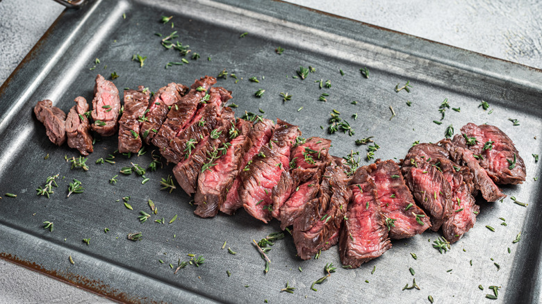 Sliced skirt steak on cutting board