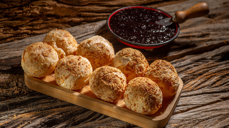 Tray of pão de queijo with dipping sauce
