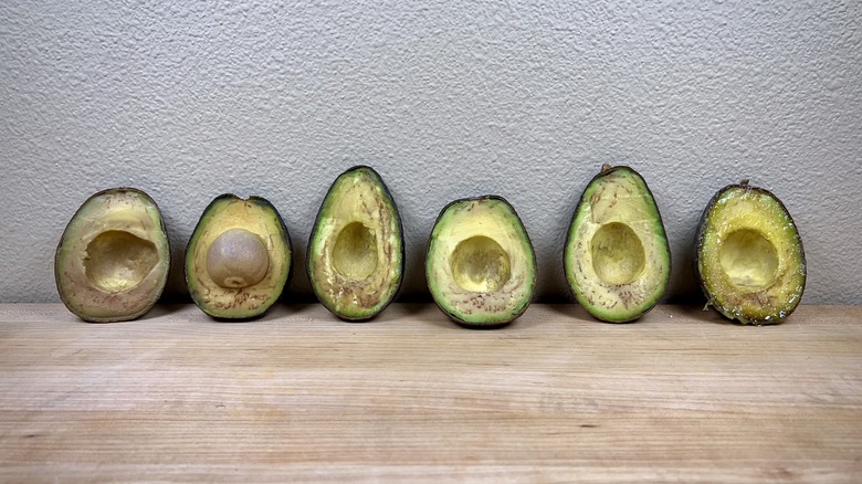 Browned avocados on cutting board