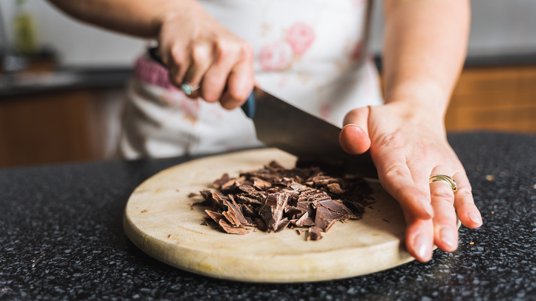 Hand chopping up chocolate 