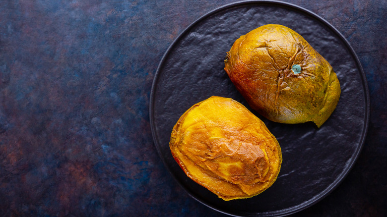 spoiled mangoes on plate