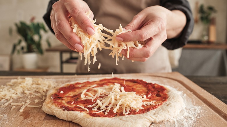 making pizza with hands