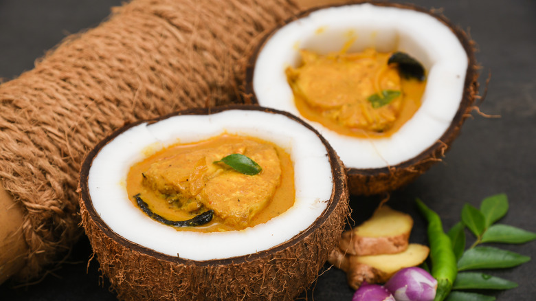 Fish and coconut curry sauce served in coconut shells