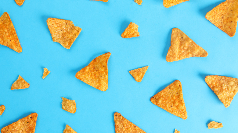 Tortilla chips on a blue background.