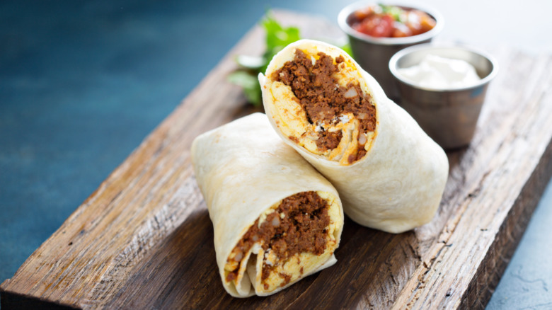 beef burritos on wood board