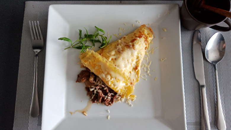 steak omelette on white plate with silverware