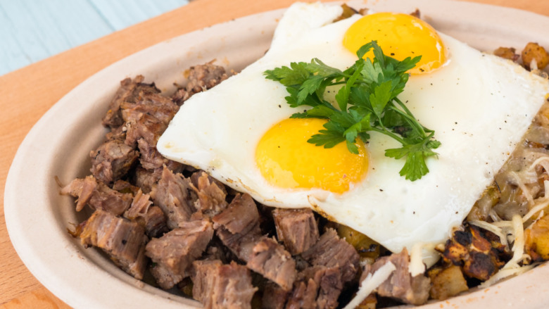 steak egg hash on white plate