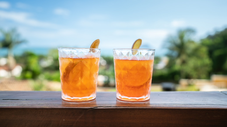 Two orange cocktails outside