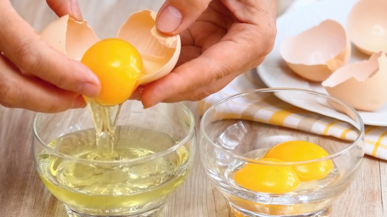 Hands separating eggs