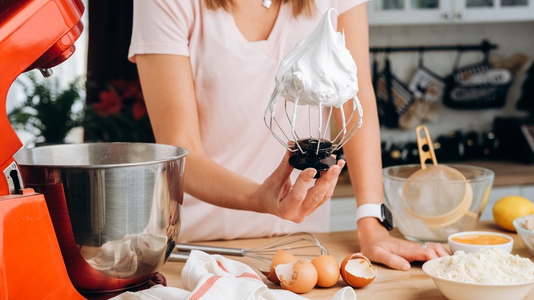 Woman holding blades with meringue