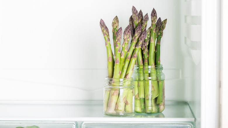 asparagus in jars with water