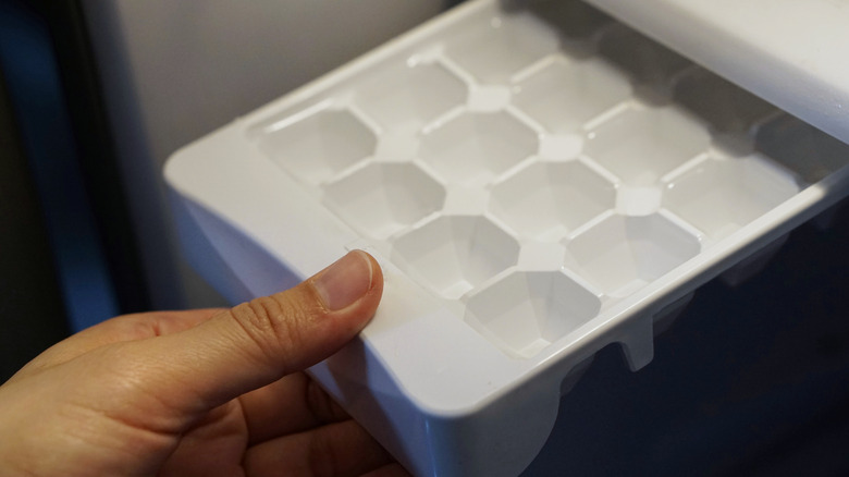 Hand removing ice cube tray