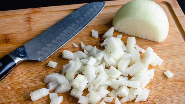 diced onion on cutting board with knife