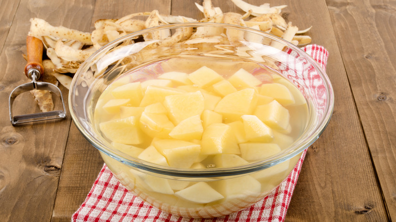 diced potatoes in glass bowl of water