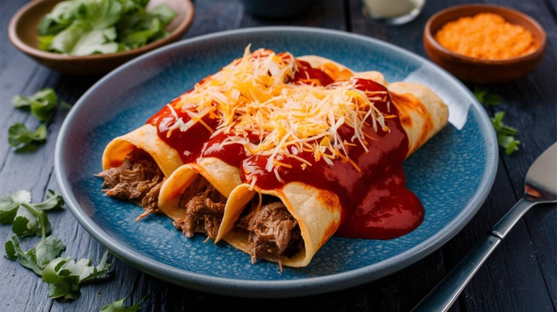 Three beef enchiladas on plate