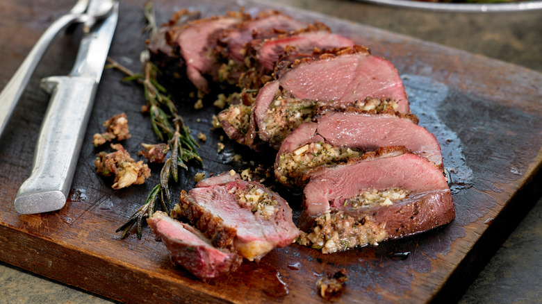 seared sliced duck breast on a carving board