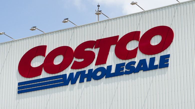 The logo for Costco Wholesale on the side of a warehouse