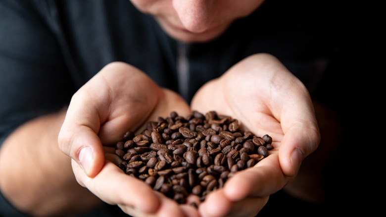 Person sniffing coffee beans