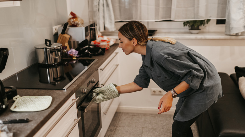 person looking in oven