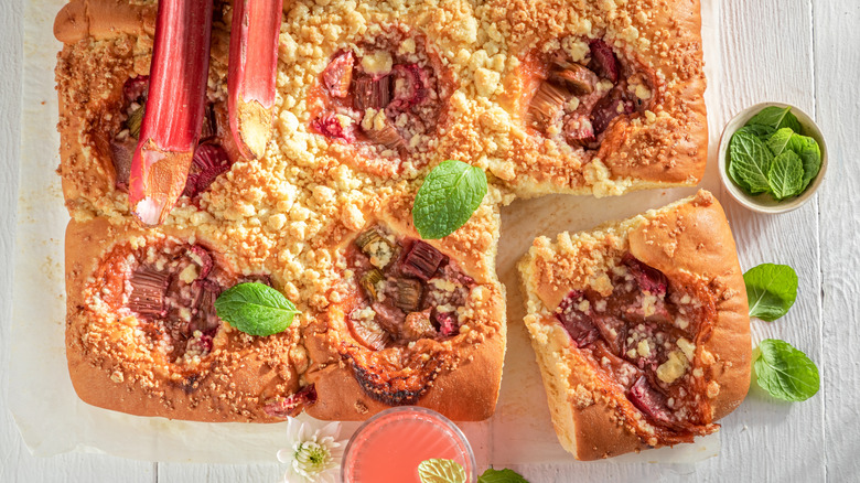 A square rhubarb cake topped with mint leaves