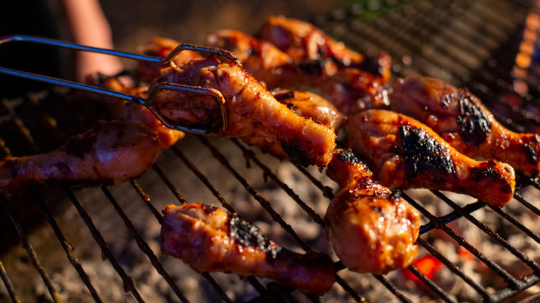 grilling drumsticks on barbecue