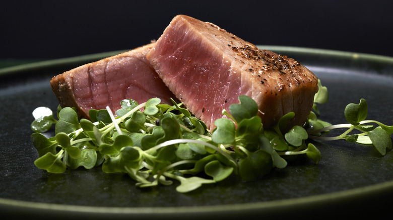 Tuna steak with greens on plate