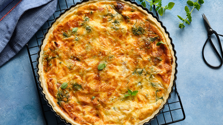 Quiche with herbs on a cooling rack