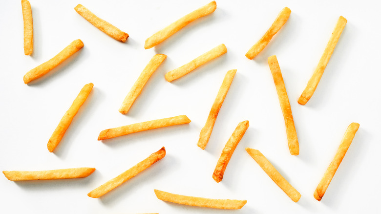Thin fries on white background