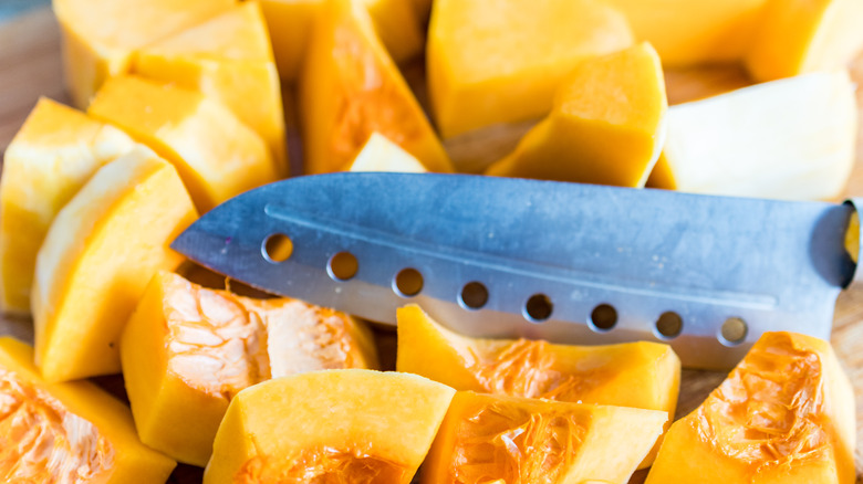 pumpkin being cut with knife