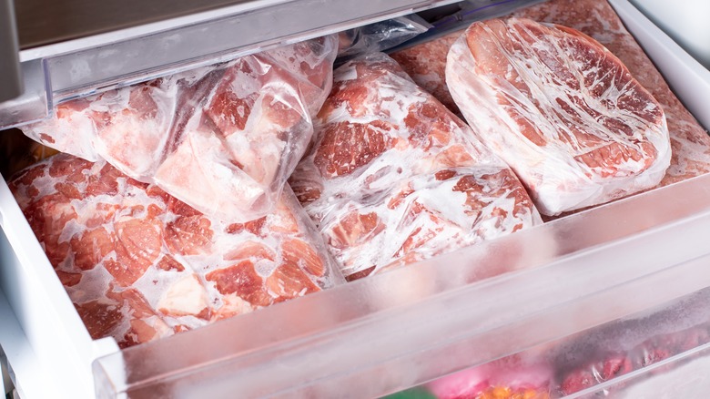 packages of frozen meat in freezer