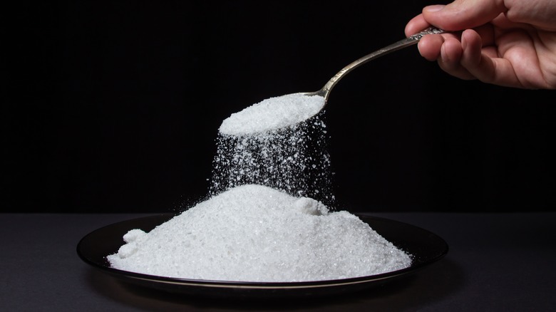 Spoon scooping salt from a bowl