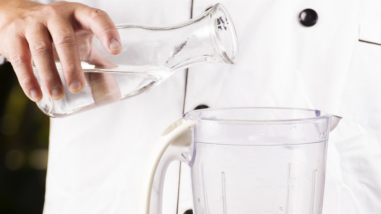 Pouring water into a blender