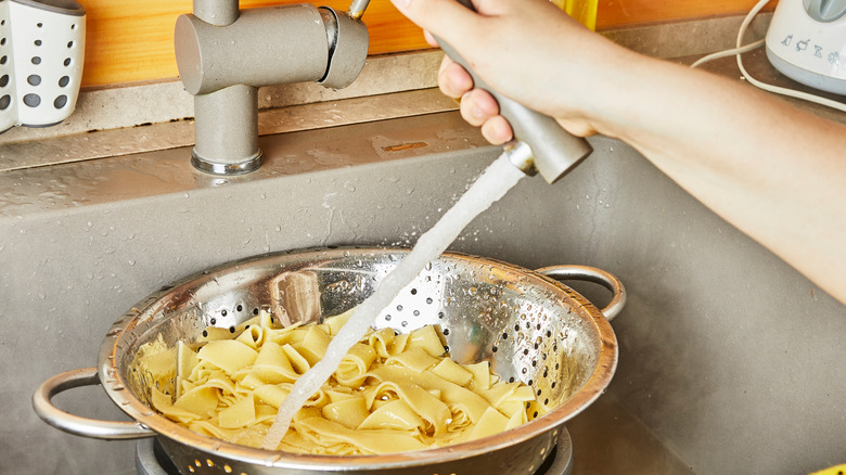 rinsing pasta in colander