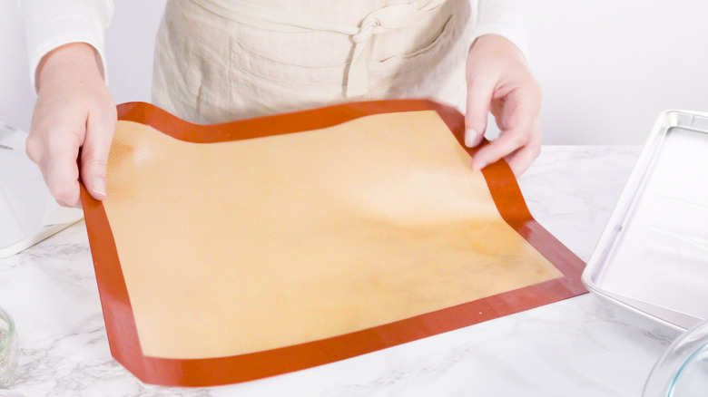 person holding silicone mat