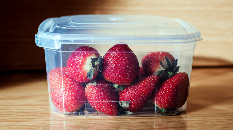 Plastic Tupperware filled with strawberries