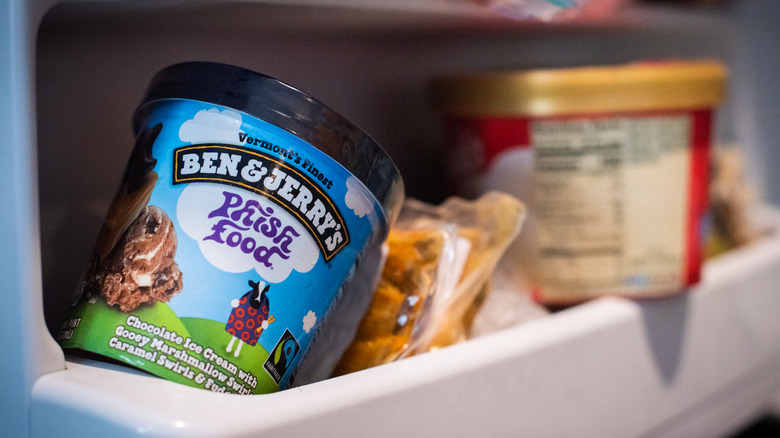 A pint of Ben & Jerry's ice cream in a freezer.