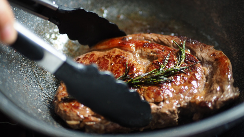 searing steak in a pan