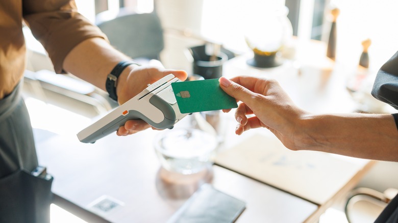 person paying with credit card in restaurant