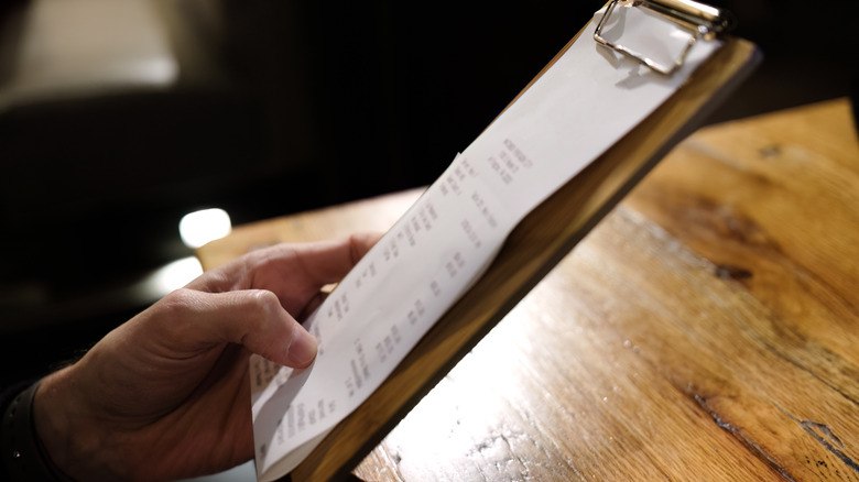person paying bill in restaurant