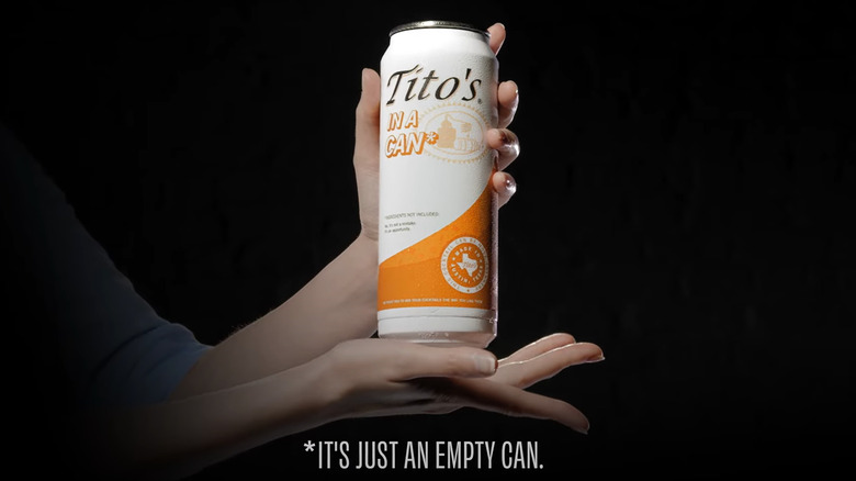 holding up tito's in a can