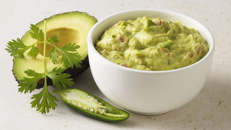 guacamole in bowl by avocado