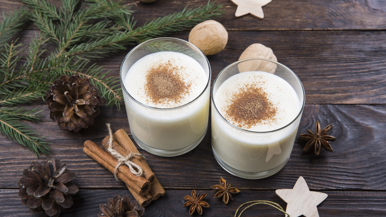 Two eggnogs with spices and pine branches