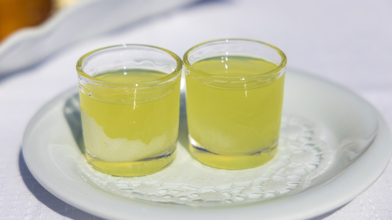 Two green tea shots on a white plate