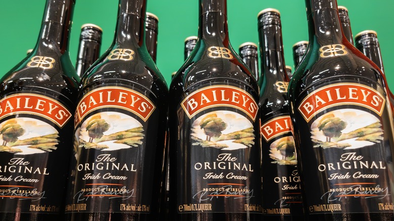 bottles of Bailey's Irish Cream with green background