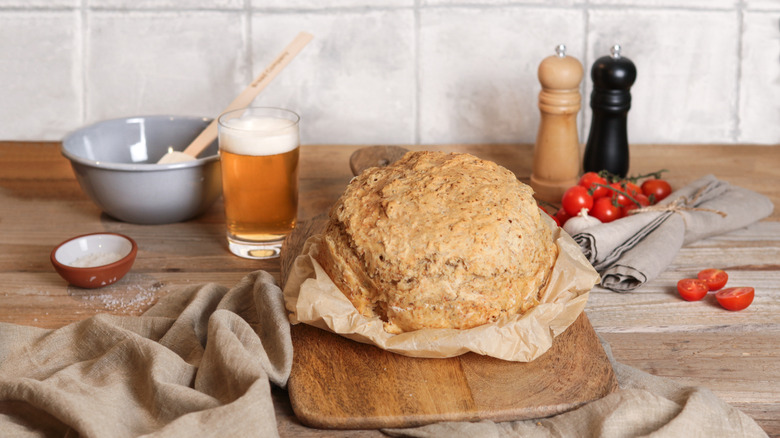 baked bread with mixing bowl and beer in background